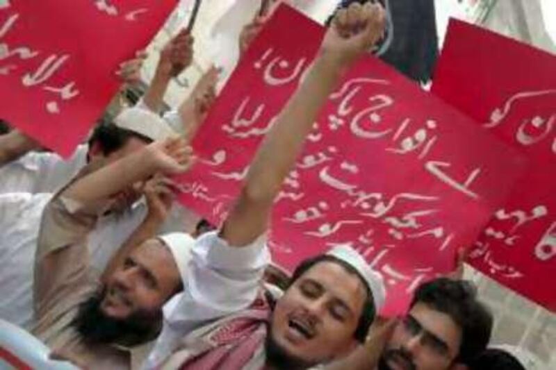 Pakistani protesters chant slogans against government as they hold a placard, center, reading "Pakistan army, you have pleased America a lot, let us please Allah (God) now" at a rally to condemn military operations against militants and Talibans in Pakistan's tribal areas, Friday, Sept. 12, 2008 in Peshawar, Pakistan. (AP Photo/Mohammad Sajjad)