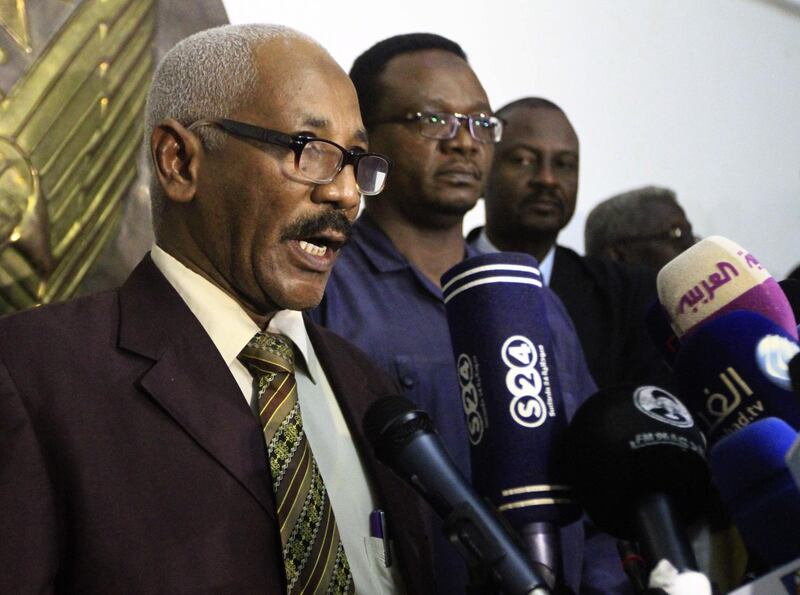 Brigadier Mohamed Hamid (L) from Sudan's National Intelligence and Security Service (NISS) speaks to the press at the airport in the capital Khartoum on July 30, 2018. 
Five Egyptian troops held hostage in Libya were freed today in a joint operation carried out by Sudanese and Egyptian intelligence services, security officers from the two countries said. / AFP PHOTO / Ebrahim Hamid