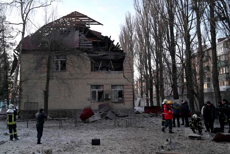 Rescue workers examine the remains of a drone after a building was hit in Kyiv. AFP