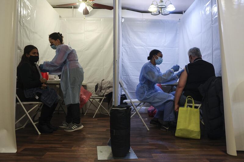 Healthcare workers administer Pfizer-BioNTech Covid-19 vaccines at a vaccination site inside a church in the Bronx borough of New York, US. Bloomberg