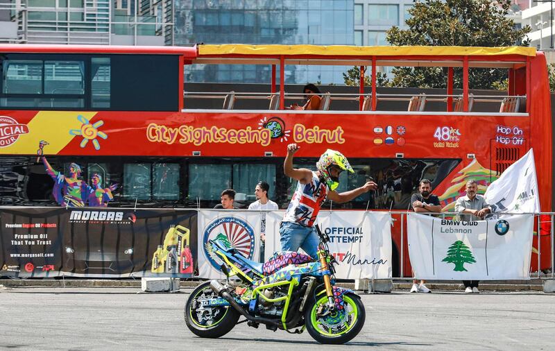 A biker performs stunts with a motorcycle during a special motoring event in the Lebanese capital Beirut outside the Mohammad al-Amin mosque in the downtown district's Martyr's Square.  AFP