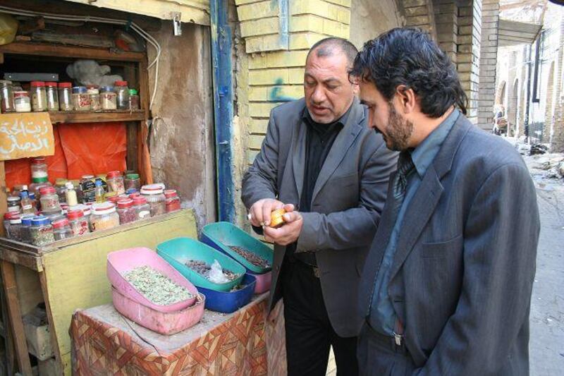 Faris Abbas, 45, talks to a customer at his Baghdad store.