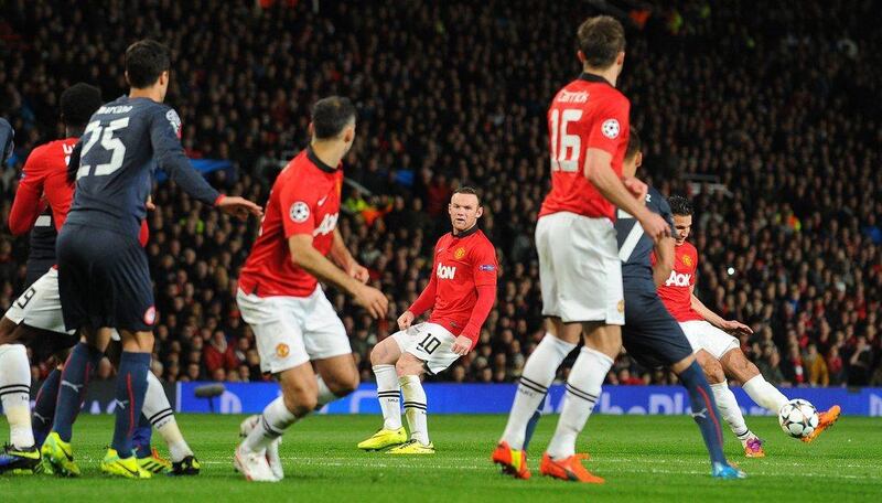 Manchester United forward Robin van Persie, right, shoots to score the third goal on Wednesday night against Olympiakos. Andrew Yates / AFP / March 19, 2014