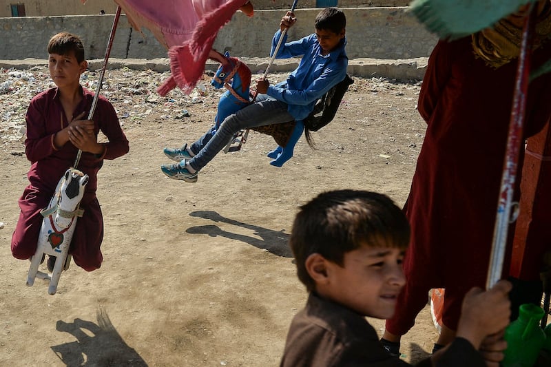 Afghan children enjoy a ride on a carousel. Photo: AFP
