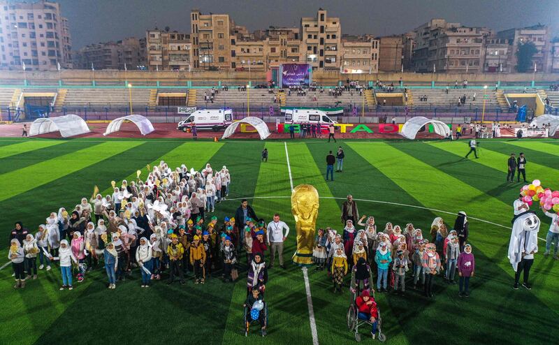 Children posing on the pitch during the opening ceremony of the Camps World Cup