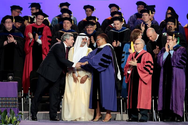 Sheikh Nahyan bin Mubarak, Minister of Culture, Youth and Community Development, watches as Gordon Brown, former British premier, greets Graca Machel, widow of Nelson Mandela, at New York University Abu Dhabi. Christopher Pike / The National