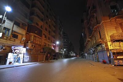 A street in the Egptian capital Cairo is deserted on the first day of a two-weeks night-time curfew imposed by the authorities to contain the spread of the novel coronavirus, on March 25, 2020.   / AFP / Khaled DESOUKI
