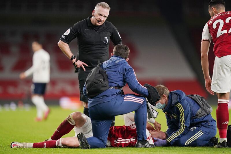 Rob Holding is treated by medical staff after the challenge by Joao Cancelo. Reuters
