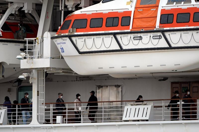 Passengers walk on a deck of the Diamond Princess.  EPA