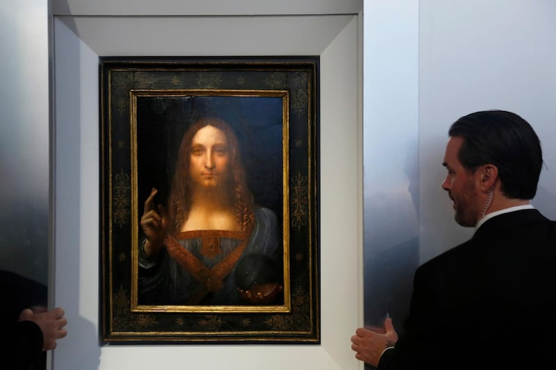 Security guards open a door to reveal "Salvator Mundi" by Leonardo da Vinci during a news conference at Christie's in New York, Tuesday, Oct. 10, 2017. The piece, which was painted around 1500, is one of fewer than twenty da Vinci paintings known to exist. After public exhibitions around the world, the auction is scheduled to take place on Nov. 15, 2017. (AP Photo/Seth Wenig)