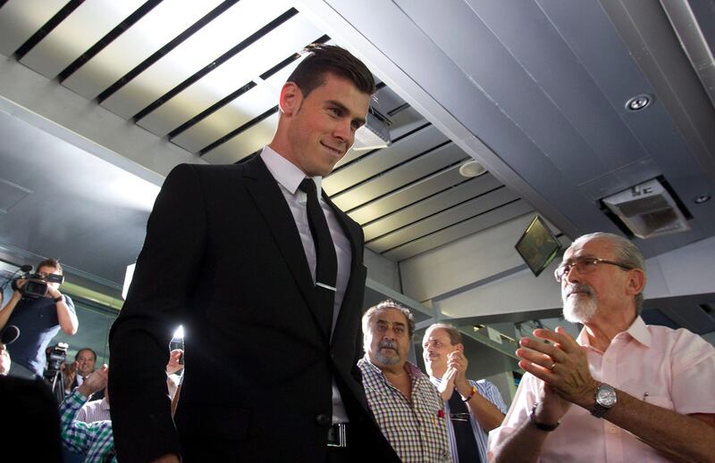 Welsh international soccer player Gareth Bale arrives for his official presentation at the Santiago Bernabeu stadium in Madrid, Monday, Sept. 2, 2013 after signing for Real Madrid. The Spanish club announced Sunday that Bale has signed a six-year contract, and a person familiar with the deal said the fee was a world-record euro100 million ($132 million). (AP Photo/Paul White) *** Local Caption ***  Spain Soccer Real Madrid Bale.JPEG-06e5c.jpg