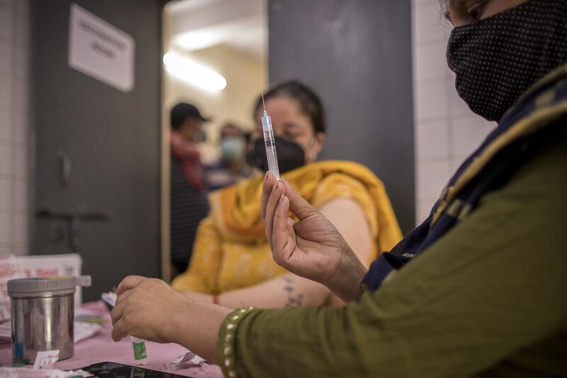 A health worker prepares a dose of a Covid-19 vaccine at a heath centre in the village of Bazrak, Uttar Pradesh. Bloomberg