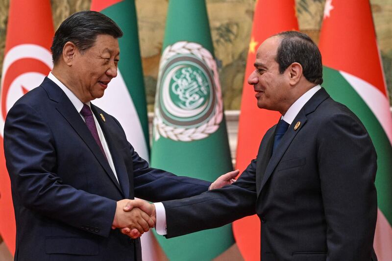 China’s President Xi Jinping greets Egypt’s President Abdel Fattah El Sisi before the opening ceremony of the summit in Beijing. AFP