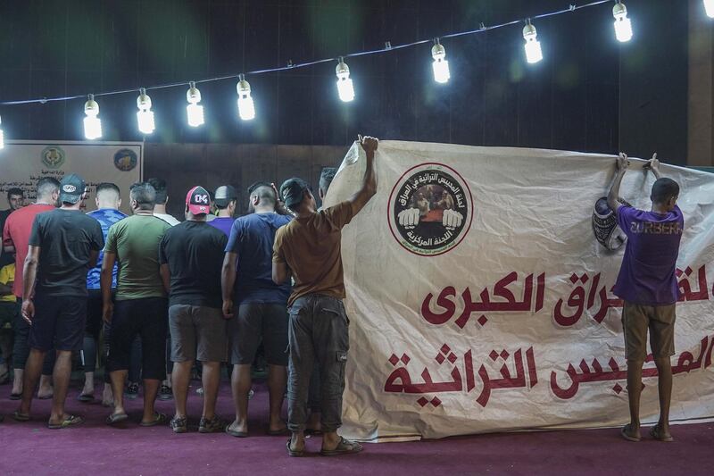 : Players covering their team members so they can hide the ring amongst them during the traditional ring tournament in Baghdad Iraq. Haider Husseini / The National