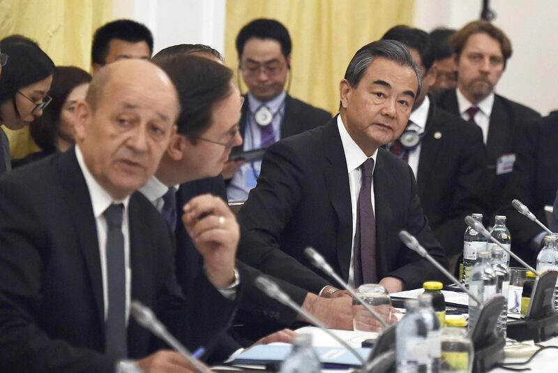 Chinese Foreign Minister Yi Wang (R) takes part in a Comprehensive Plan of Action (JCPOA) ministerial meeting on the Iran nuclear deal on July 6, 2018 in Vienna, Austria. The foreign ministers of Iran and five world powers meet to try to salvage the nuclear deal two months after President Donald Trump announced a unilateral US withdrawal.  - Austria OUT
 / AFP / APA / HANS PUNZ
