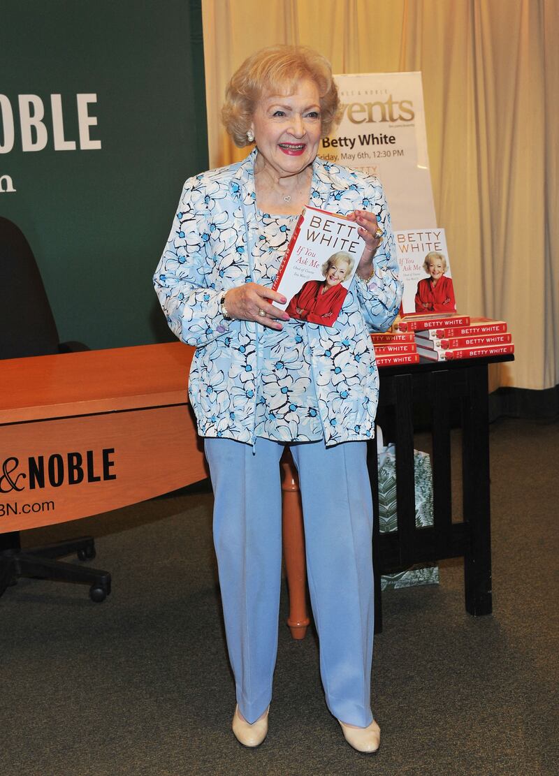 Betty White, in blue trousers and a blue floral twin set, signs copies of 'If You Ask Me (And Of Course You Won't)' at Barnes & Noble, New York City on May 6, 2011. AFP
