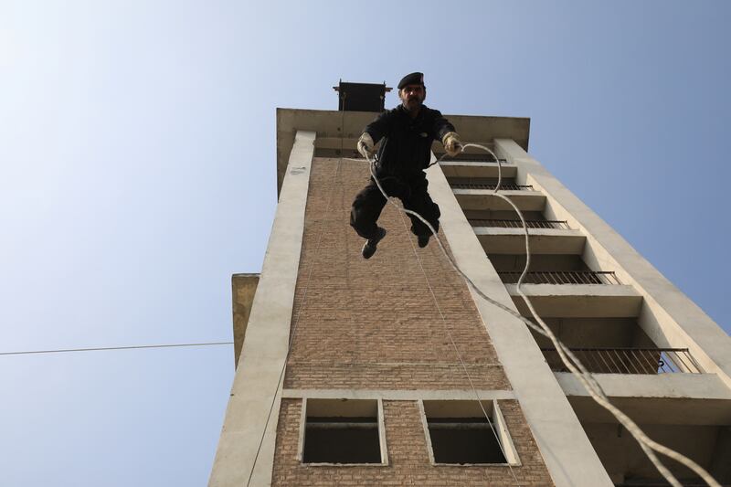 A police officer rappels off a building during a practice session at the Elite Police Training Centre in Nowshera, Pakistan. Reuters