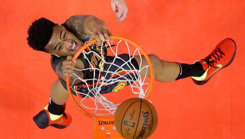 Atlanta Hawks forward John Collins dunks during the first half of a basketball game against the Los Angeles Clippers in Los Angeles. Mark Terrill / AFP