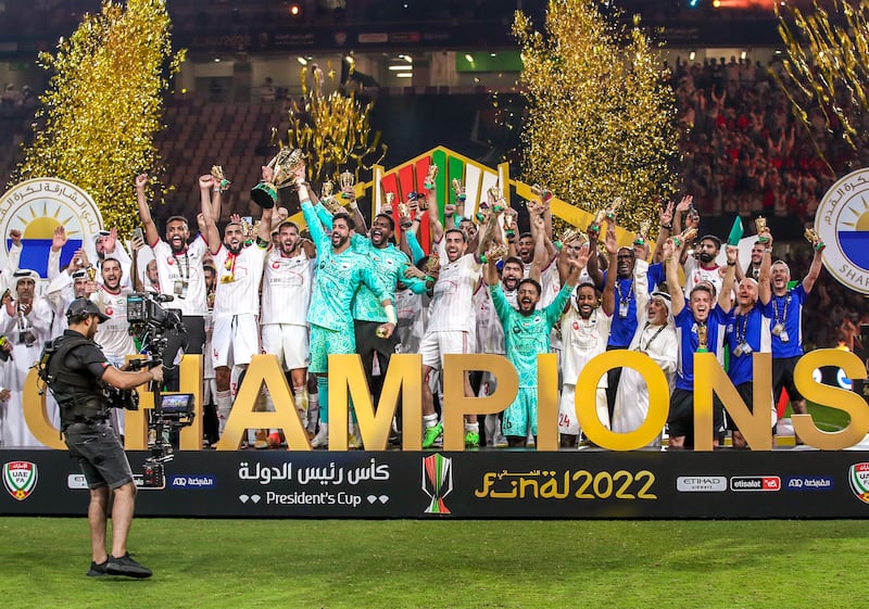 Sharjah players and staff celebrate winning the 2022 President’s Cup after defeating Al Wahda 1-0 at the Hazza bin Zayed Stadium in Al Ain. Victor Besa / The National