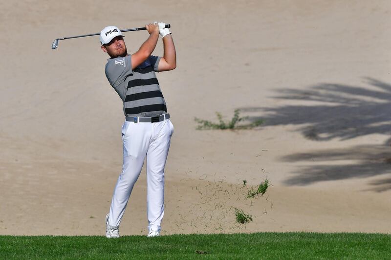 Tyrrell Hatton of England plays a shot during the round one of the Dubai Desert Classic Golf Championship, at the Emirates Golf Club in Dubai on January 25, 2018. / AFP PHOTO / GIUSEPPE CACACE