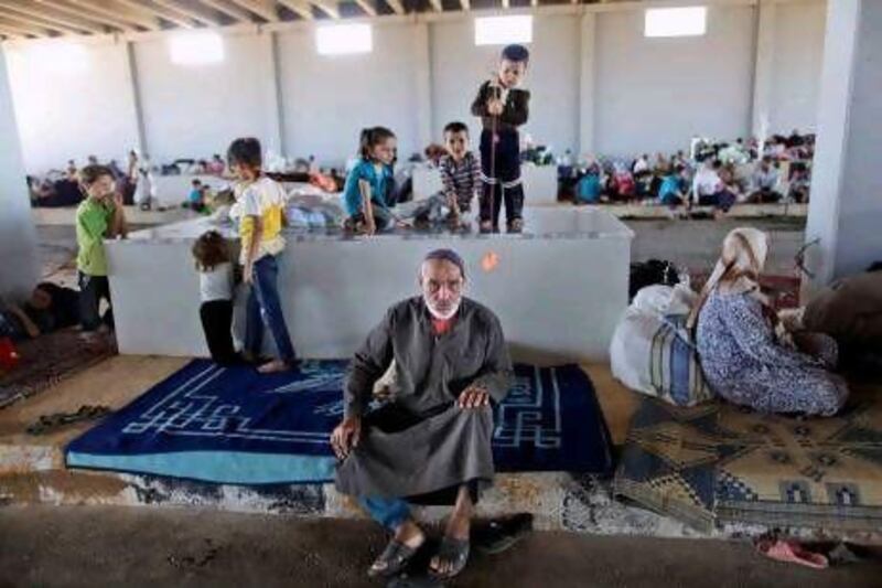 An elderly Syrian man, who fled his home due to the civil war, takes refuge at the Bab Al Salameh border crossing with hopes of entering one of the refugee camps in Turkey. Another 74,112 Syrian refugees are housed in Turkey.