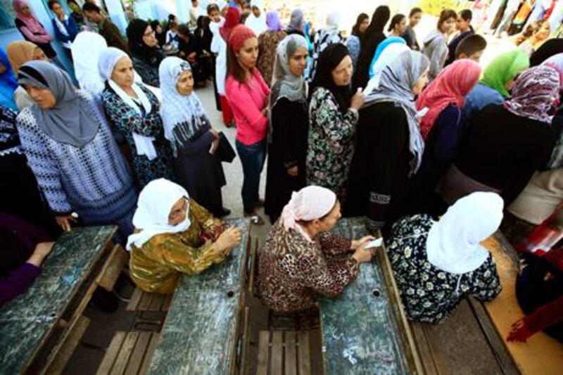 Tunisian women queue to cast their ballots at a polling station during an election in Tunis October 23, 2011. The election, the first free vote in Tunisia's history, will set a standard for other Arab countries where uprisings have triggered political change or governments have tried to rush reforms to stave off unrest. REUTERS/Zohra Bensemra (TUNISIA - Tags: POLITICS ELECTIONS)