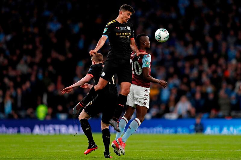 Manchester City midfielder Rodri climbs to win a header from Aston Villa striker Mbwana Samatta. AFP