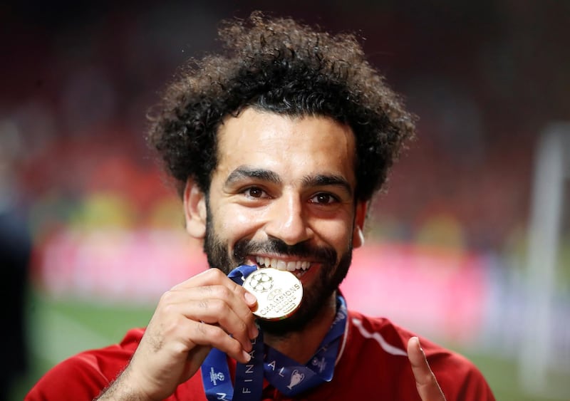 Salah celebrates with his medal for winning the Champions League. Reuters