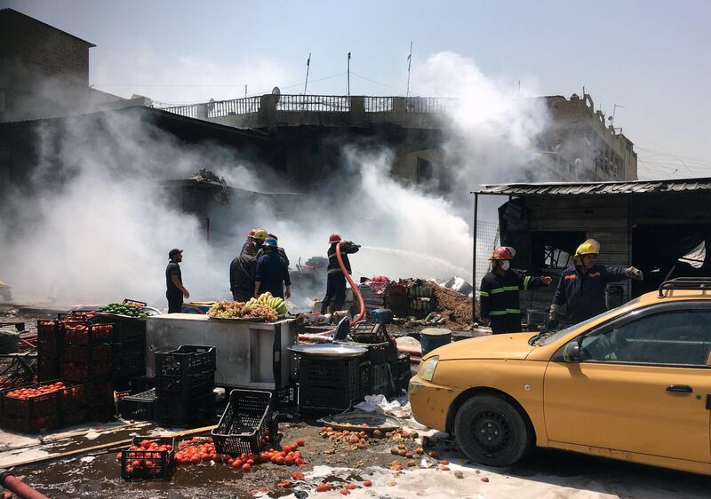 A firefighter hoses down at the site of a car bomb attack in Jamela market in Sadr City district of Baghdad, Iraq August 28, 2017. REUTERS/Wissm al-Okili