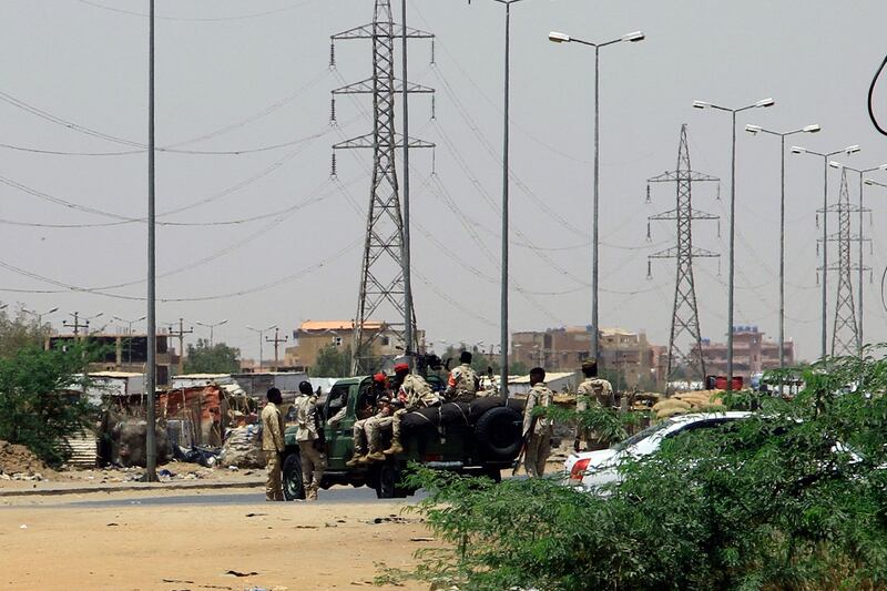 Government soldiers stationed on a key road in Khartoum. AFP