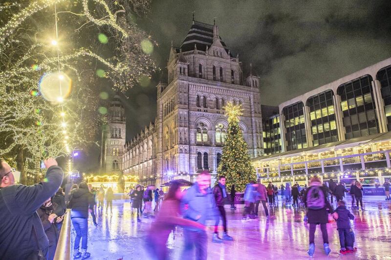 Christmas time decoration in London. Evening outside of the Natural History Museum of London with Christmas decoration, a carousel, an Ice Rink and a Christmas tree. (Photo by Nicolas Economou/NurPhoto via Getty Images)