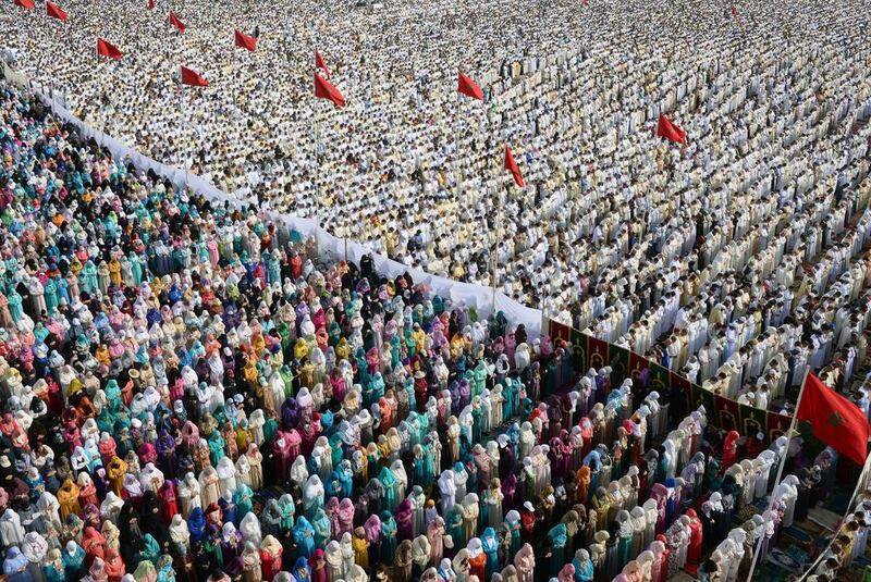 Moroccan Muslim women, left, and men, right, perform prayers for Eid Al Fitr which marks the end of the Muslim holy fasting month of Ramadan in the city of Sale, north of the Moroccan capital Rabat, on July 18, 2015. Fadel Senna / AFP photo