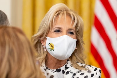 US first lady Jill Biden wears a face mask embroidered with a sunflower, the national flower of Ukraine. EPA
