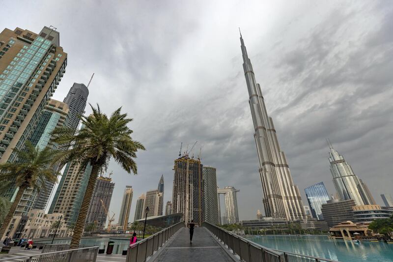 Dubai, United Arab Emirates - Reporter: N/A. Standalone. Dark clouds and rain surround the Burj Khalifa. Tuesday, December 10th, 2019. Downtown, Dubai. Chris Whiteoak / The National