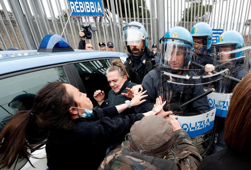 The relatives of inmates clashe with police outside of Rebibbia Prison during a prisoners' revolt, after family visits were suspended due to fears over coronavirus contagion, in Rome, Italy. Reuters