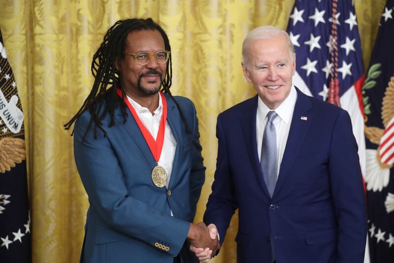 Mr Biden presents author Colson Whitehead with a National Humanities Medal. EPA 