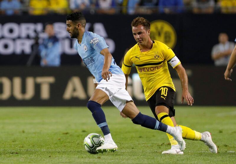 Manchester City's Riyad Mahrez in action with Borussia Dortmund's Mario Gotze. Reuters