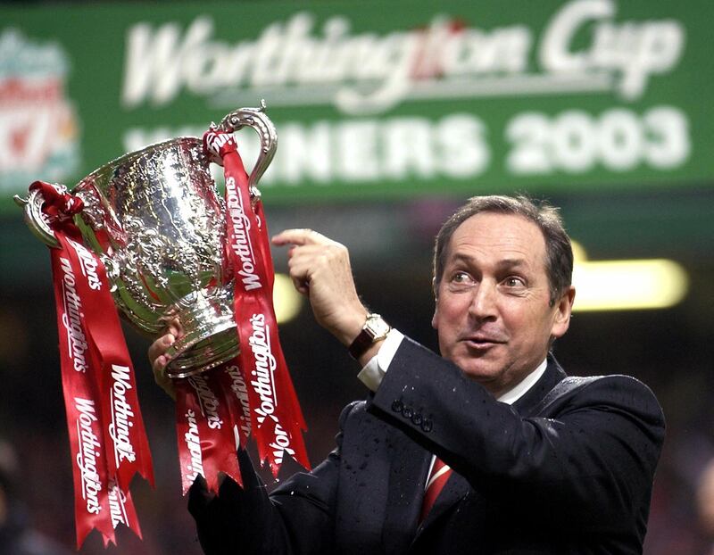 (FILES) In this file photo taken on March 2, 2003 Liverpool's French manager Gerard Houllier holds the cup aloft celebrating victory over Manchester United in the Worthington cup final at the Millenium stadium in Cardiff. - Ex-Liverpool manager Gerard Houllier has died at the age of 73, it was announced on December 14, 2020. (Photo by Odd ANDERSEN / AFP)