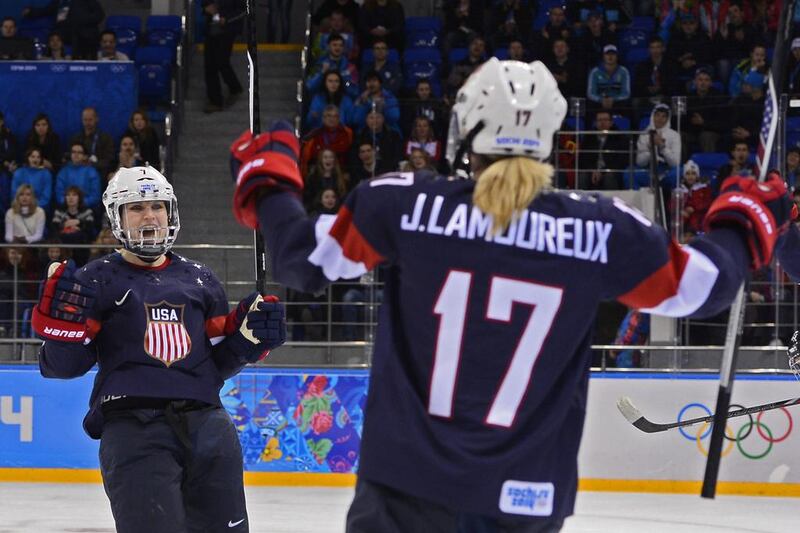Monique Lamoureux (L) reacts after her goal that was assisted by teammate Jocelyne Lamoureux (R) of United States against Switzerland. Larry Smith / EPA