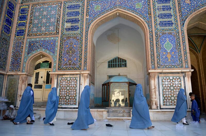 Afghan burqa-clad women walks through the courtyard of Jama Mosque during Eid al-Adha prayers in Herat on September 1, 2017. 
Afghans have started celebrating Eid al-Adha or "Feast of the Sacrifice", which marks the end of the annual Hajj or pilgrimage to Mecca and is celebrated in remembrance of Abraham's readiness to sacrifice his son to God. / AFP PHOTO / HOSHANG HASHIMI