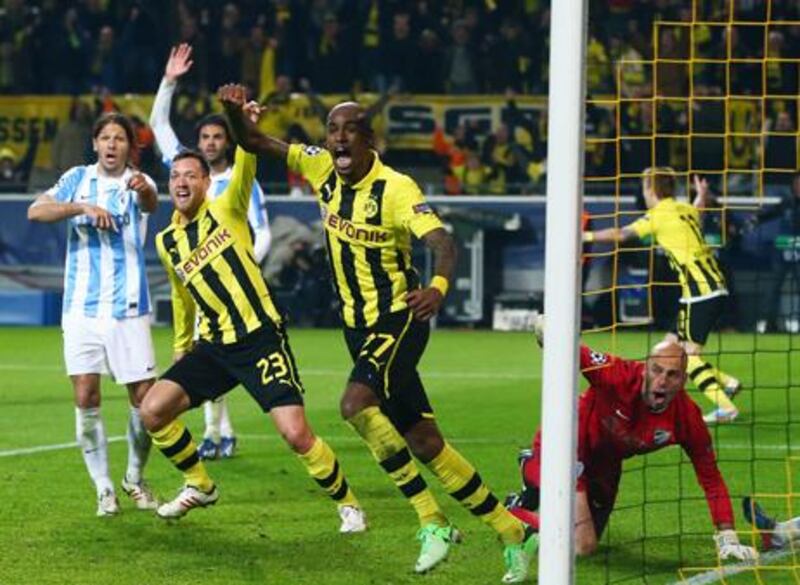 Felipe Santana (C) of Borussia Dortmund celebrates scoring their third and winning goal with team mate Julian Schieber. Alex Grimm / Bongarts / Getty Images