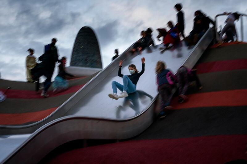 A girl slides at a playground in Barcelona, Spain. AP Photo