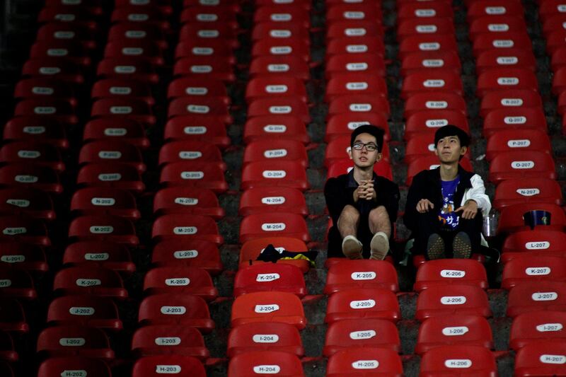 Japanese fans look on from the stands. AFP