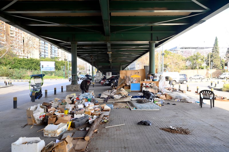 Mohammed Maghrabi inspects books under Fiat bridge in Beirut.