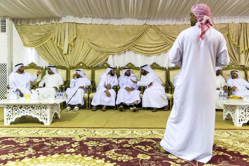 Al Ain, United Arab Emirates, August 13, 2017:    Men gather to pay their respects to the family of Captain Ahmed Khalifa Al Baloushi, 27, a UAE soldier who died in a helicopter crash while serving in Yemen,at a majalis outside the Al Towayya mosque in the Al Towayya area of Al Ain on August 13, 2017. Christopher Pike / The National

Reporter: Nawal Al Ramahi
Section: News