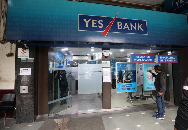 epa08274288 A person stands at a Yes Bank branch in New Delhi, India, 06 March 2020. ccording to media reports, the Reserve Bank of India (RBI) has seized control of India's Yes Bank and has caped withdrawal at 50,000 Indian rupee (678 US dollar) per account.  EPA/RAJAT GUPTA