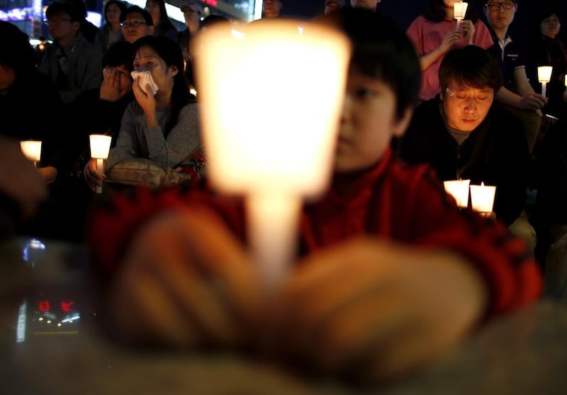 People take part in a candlelight vigil in Ansan, to commemorate the victims of the sunken passenger ship Sewol and to wish for the safe return of missing passengers. Issei Kato / Reuters / April 25, 2014