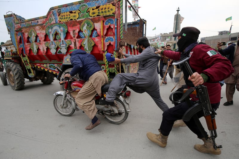 Pakistani police clash with protesters in Peshawar during a demonstration on Monday in support of former prime minister Imran Khan, jailed on corruption charges. EPA