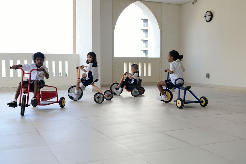 Grade 1 pupils enjoy riding tricycles at school. 