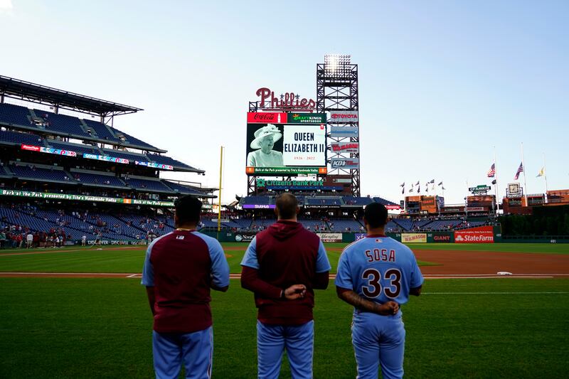Philadelphia Phillies' players stand before a baseball game against the Miami Marlins for a tribute to Queen Elizabeth in Philadelphia, Pennsylvania. AP